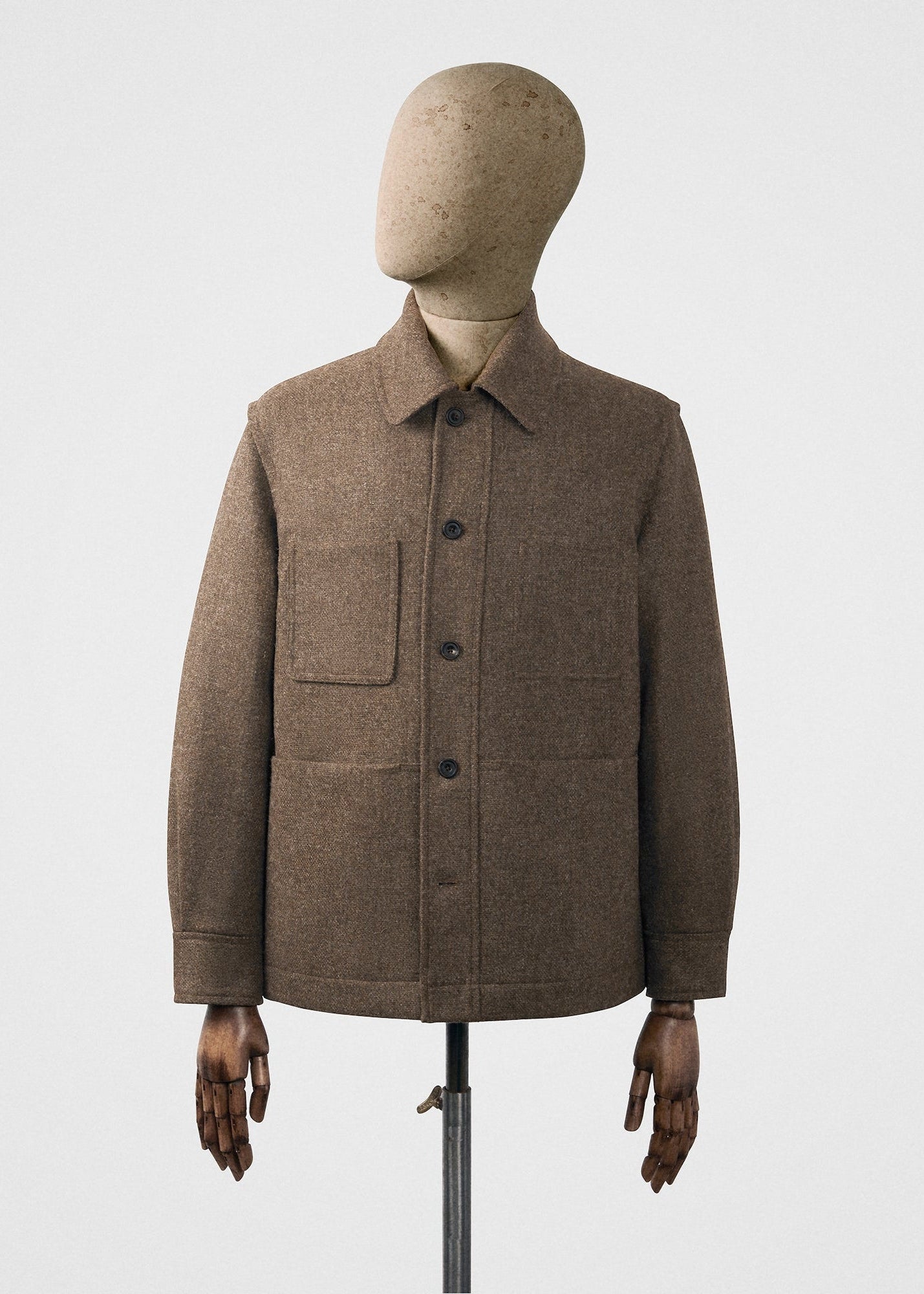 Brown jacket on a mannequin against a white background
